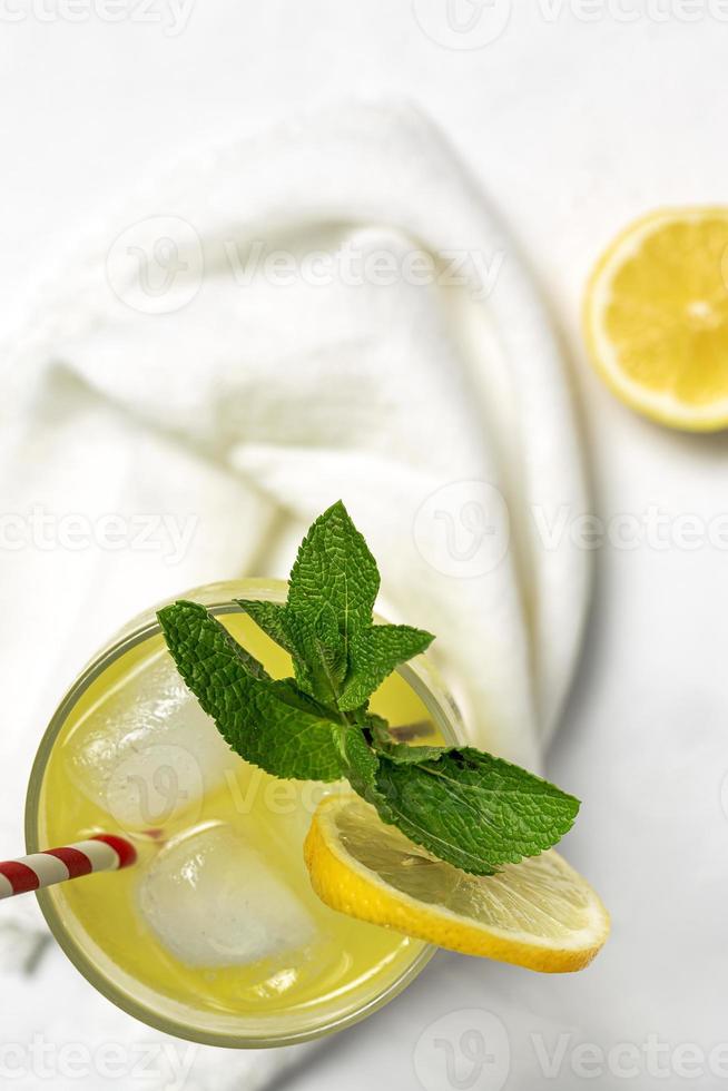 Fresh Lemonade or mojito cocktail with lemon, mint and ice photo