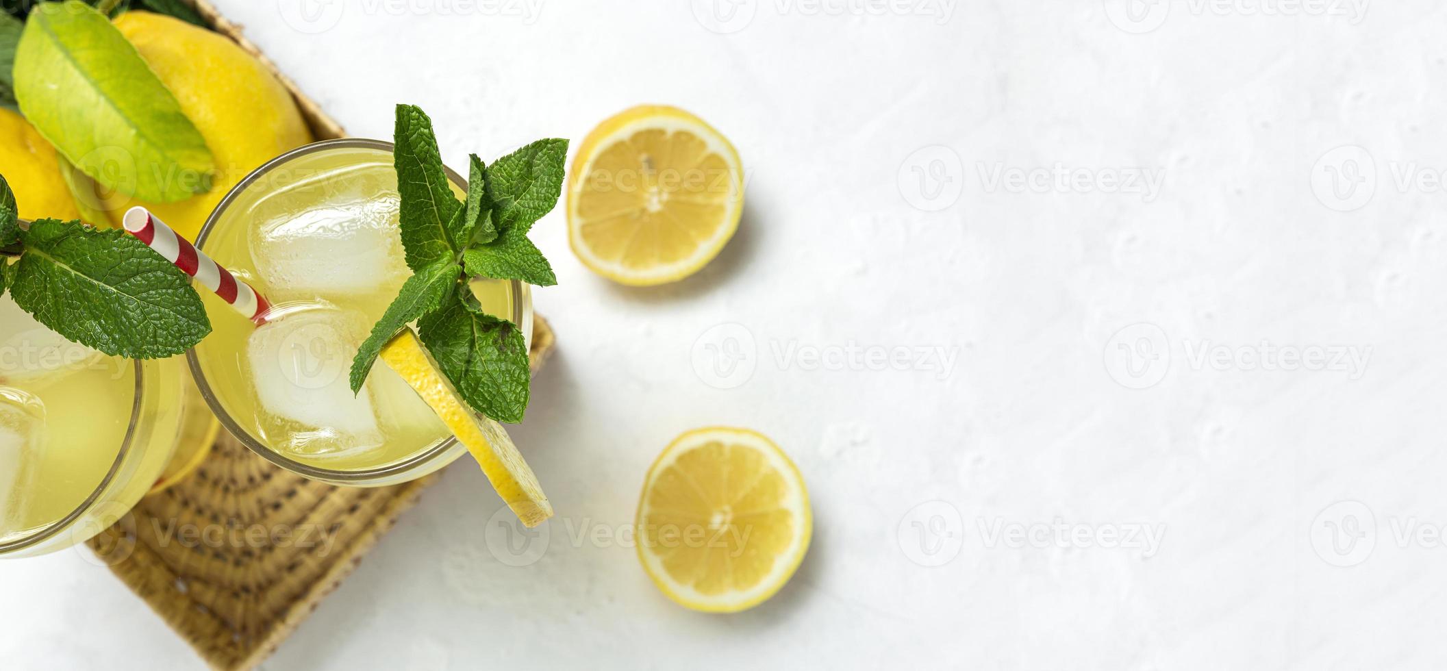 Fresh Lemonade or mojito cocktail with lemon, mint and ice photo