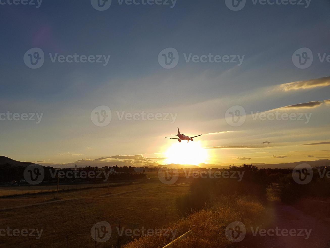 plane approaching landing in a sunset photo