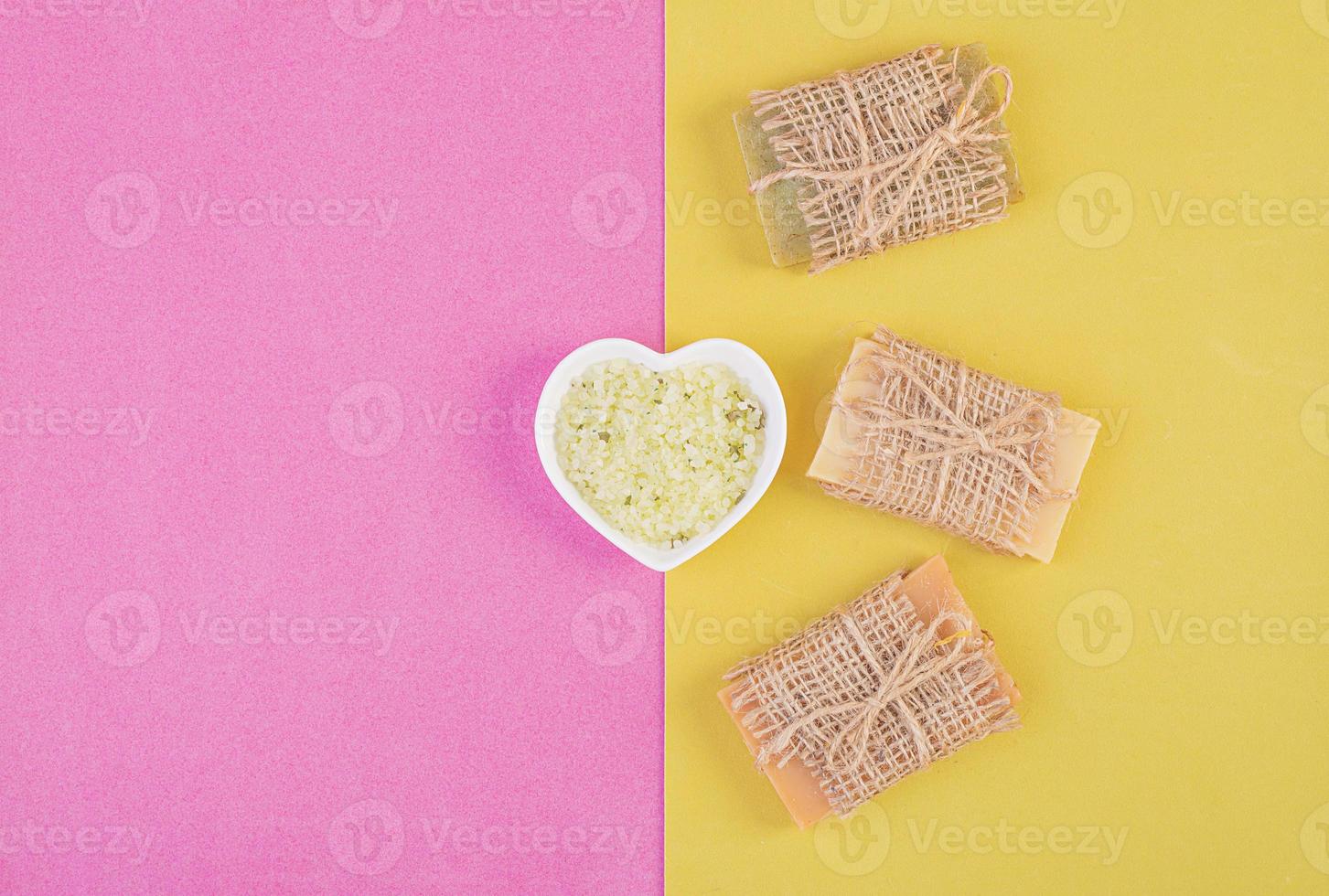 Hand made soap bars on pink-yellow background. Top view. Mockup for design photo