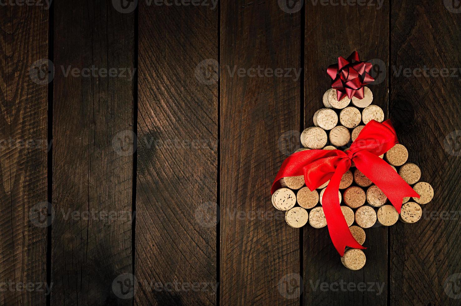 Christmas tree made of wine corks on wooden background. Mockup postcard with Christmas tree and copy space for text. Top view. photo