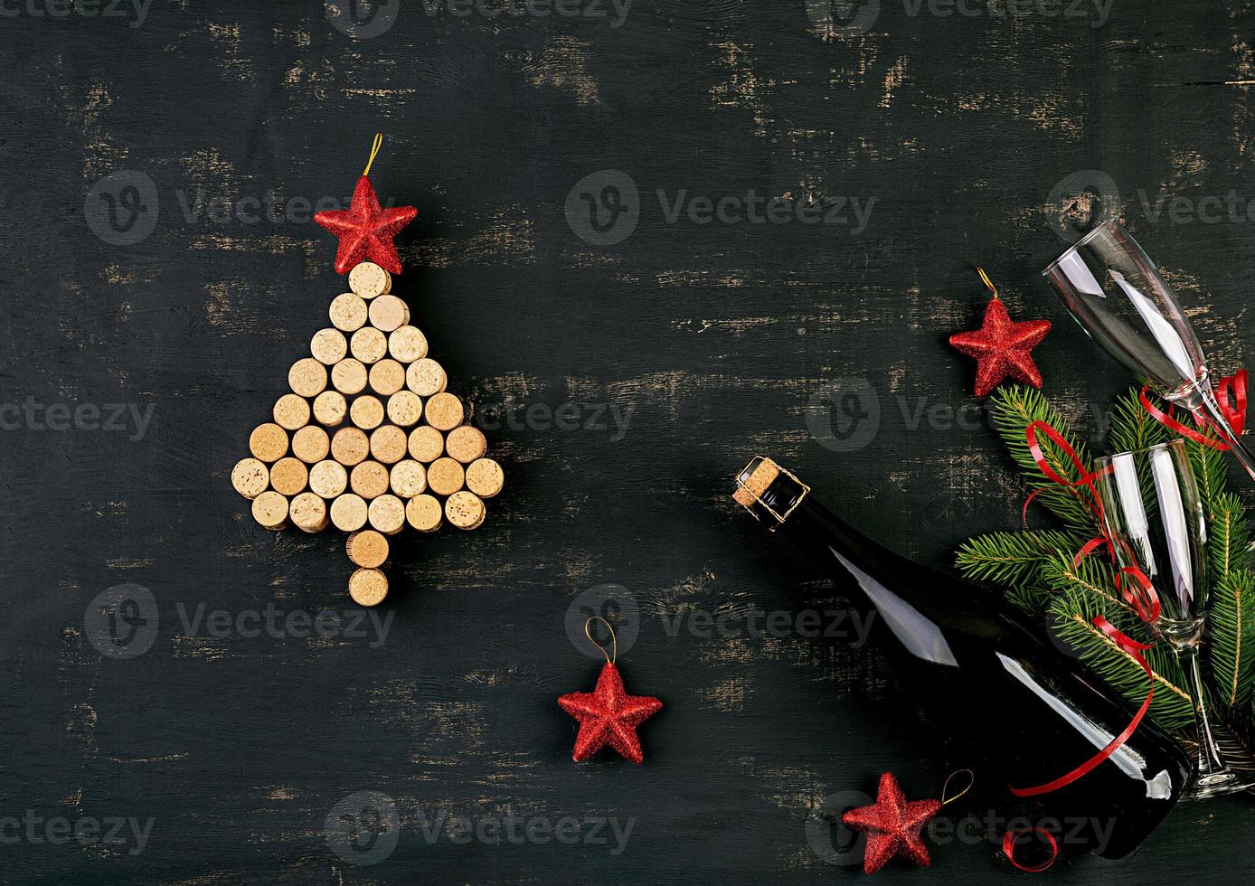 New Year decoration with christmas tree made of wine corks and bottle of champagne. Christmas background. Top view. photo