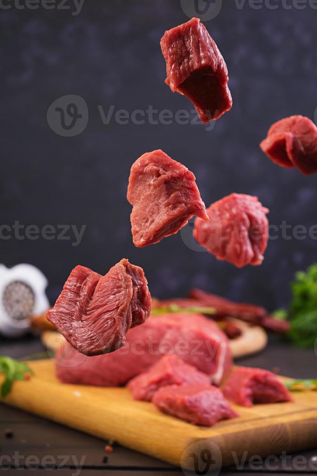 Raw meat. Fresh beef on wooden background photo