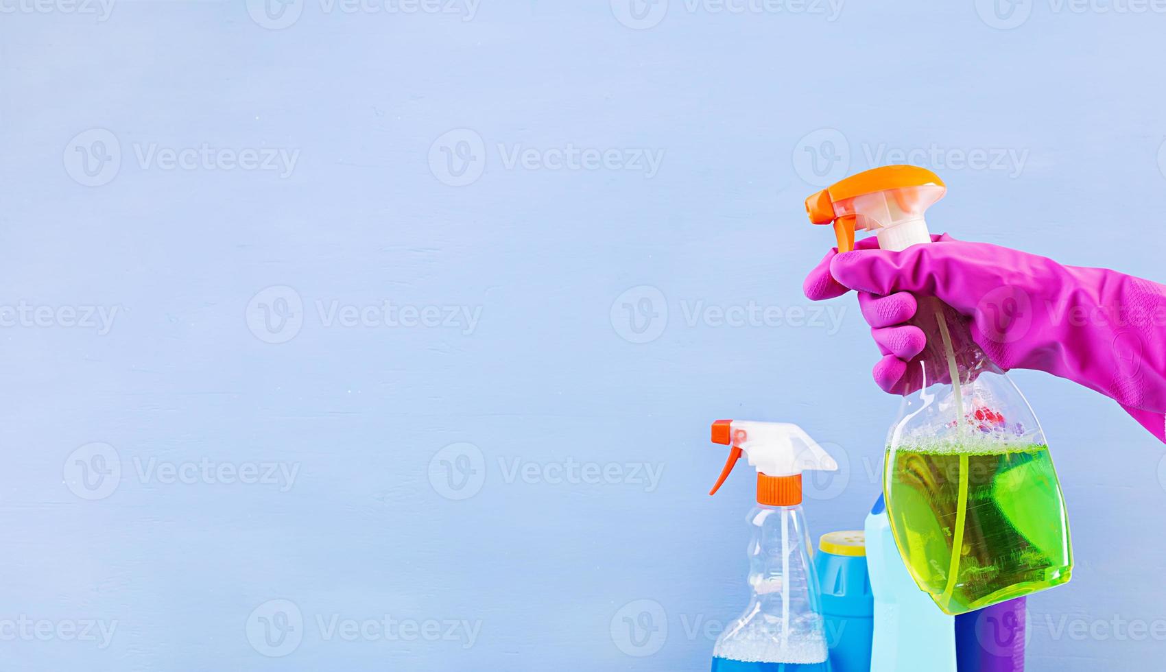 Cleaning service concept. Colorful cleaning set for different surfaces in kitchen, bathroom and other rooms. Banner. photo