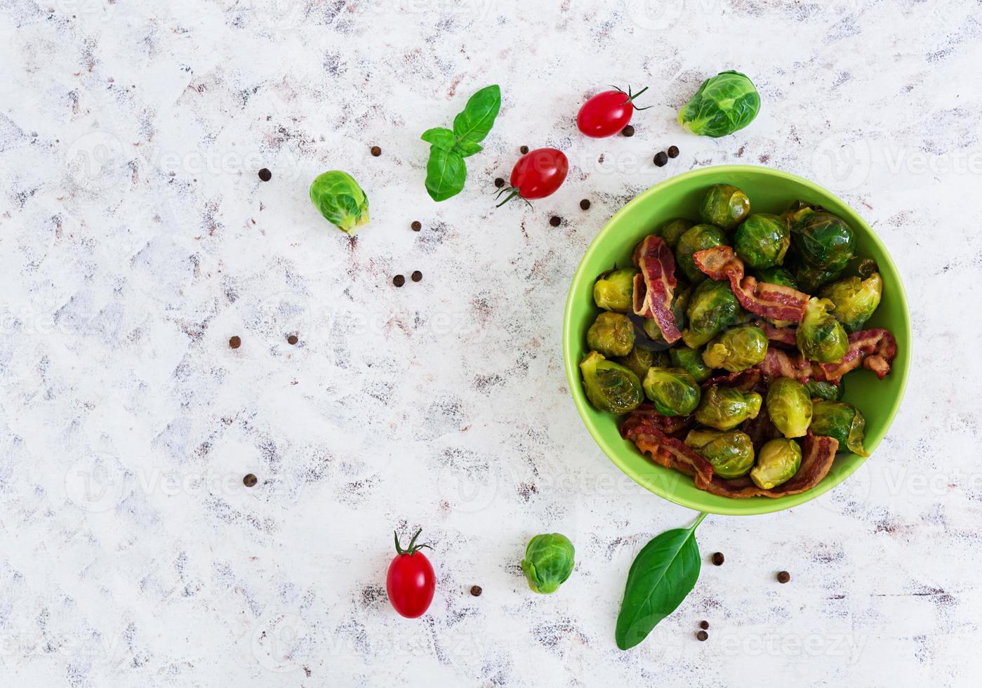 Roasted brussels sprouts with bacon on white background. Top view photo