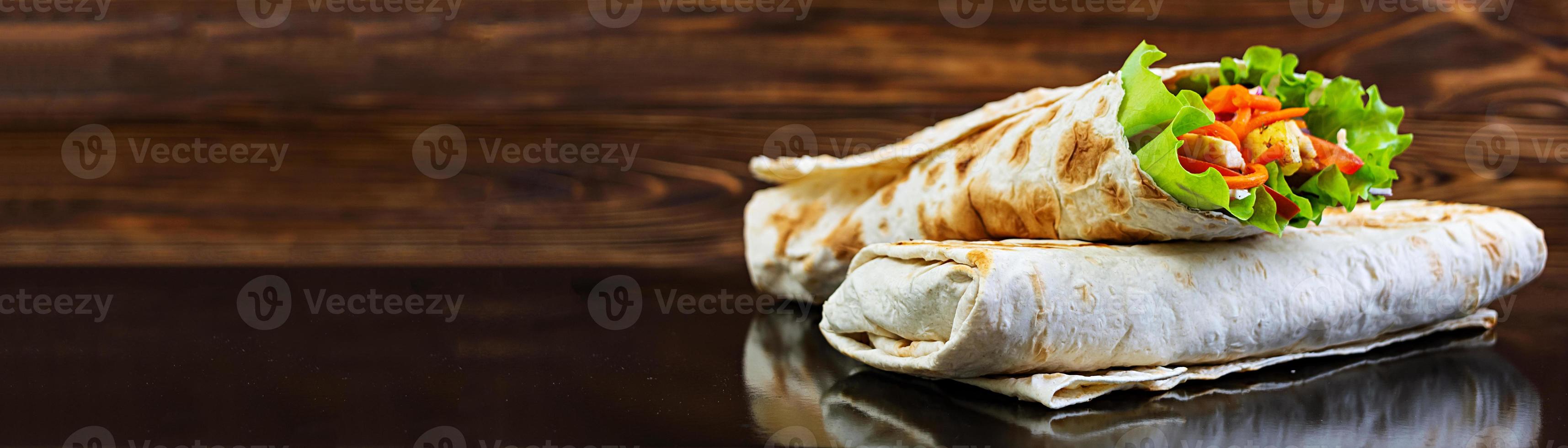 Delicious shawarma sandwich on wooden background. Banner. photo