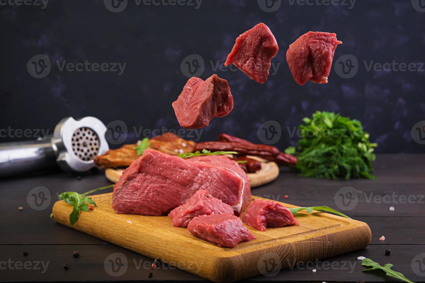 Raw meat. Fresh beef on wooden background photo