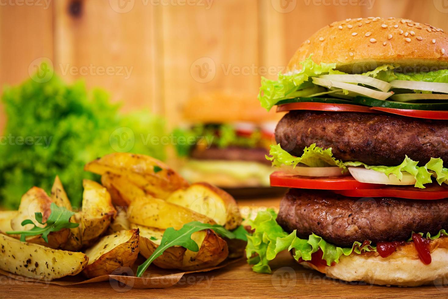 Delicious handmade burger on wooden background. Close view photo