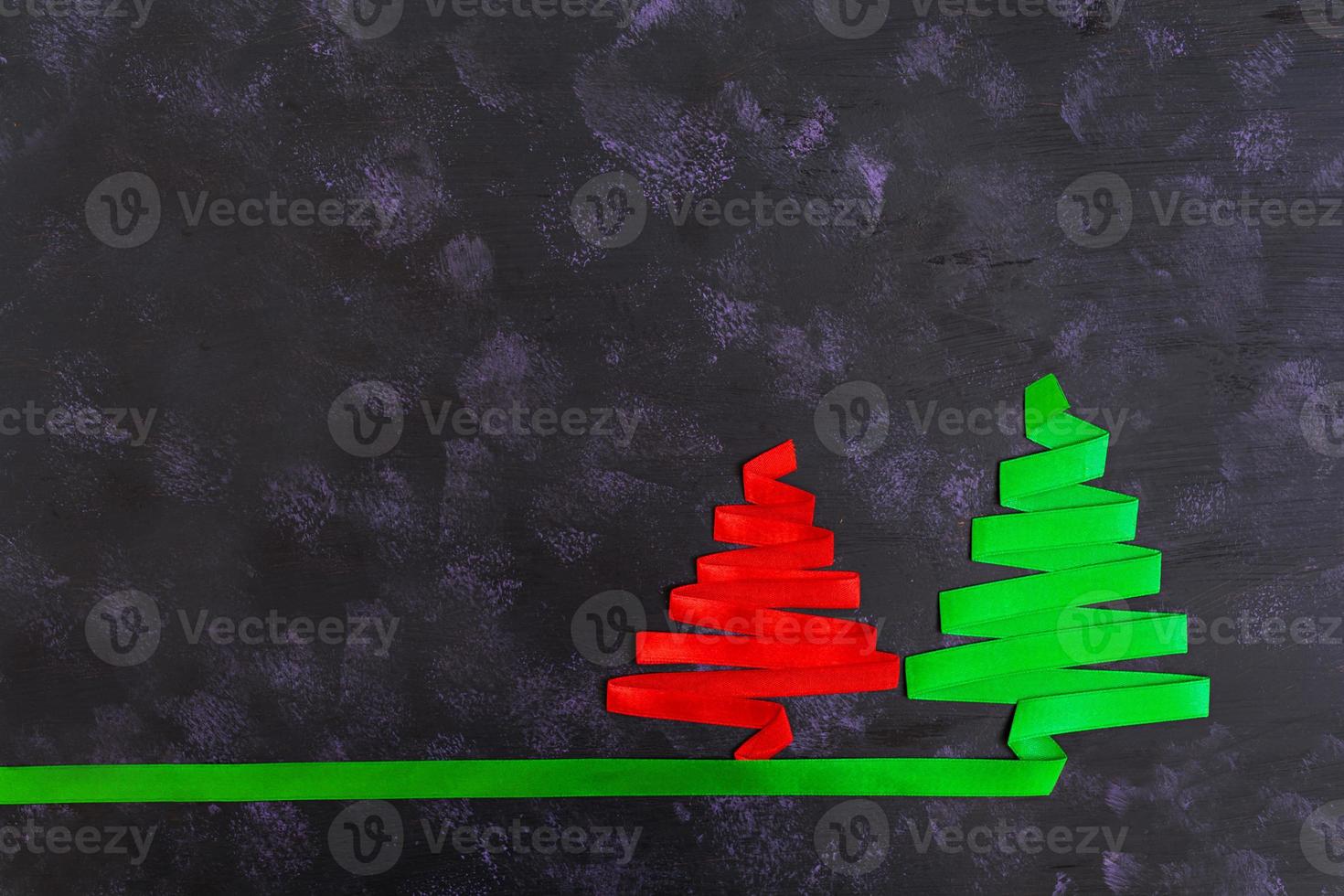 Christmas tree made of ribbon on dark background. photo