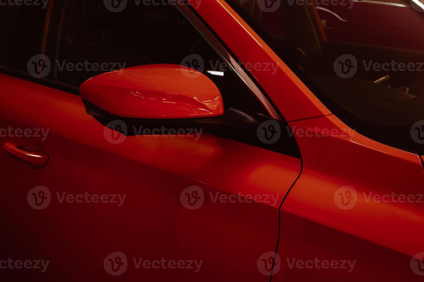 Close-up side mirrors of red car for parking safety. photo