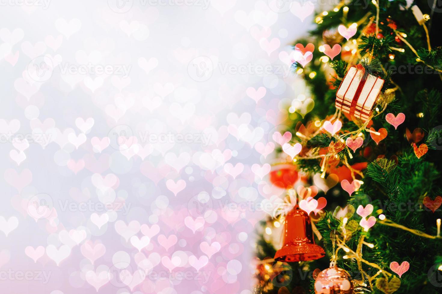 Close-up gift box on Christmas tree with abstract bokeh light background. photo