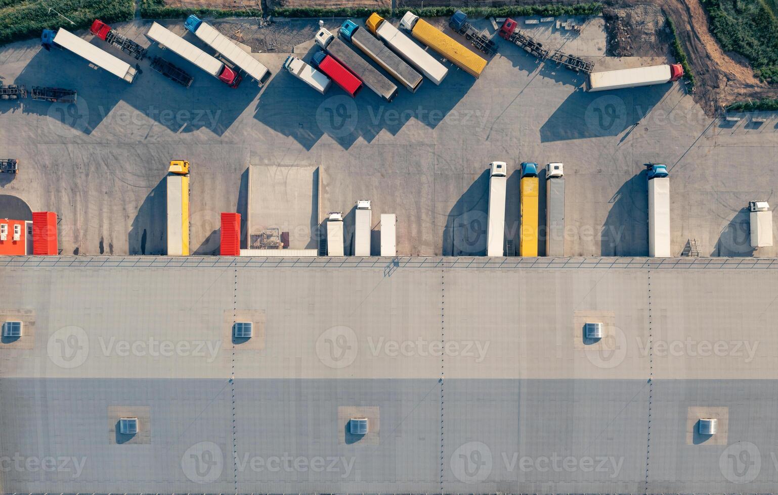 Trucks are loaded and unloaded in the cargo terminal - aerial top vu drone shot. photo