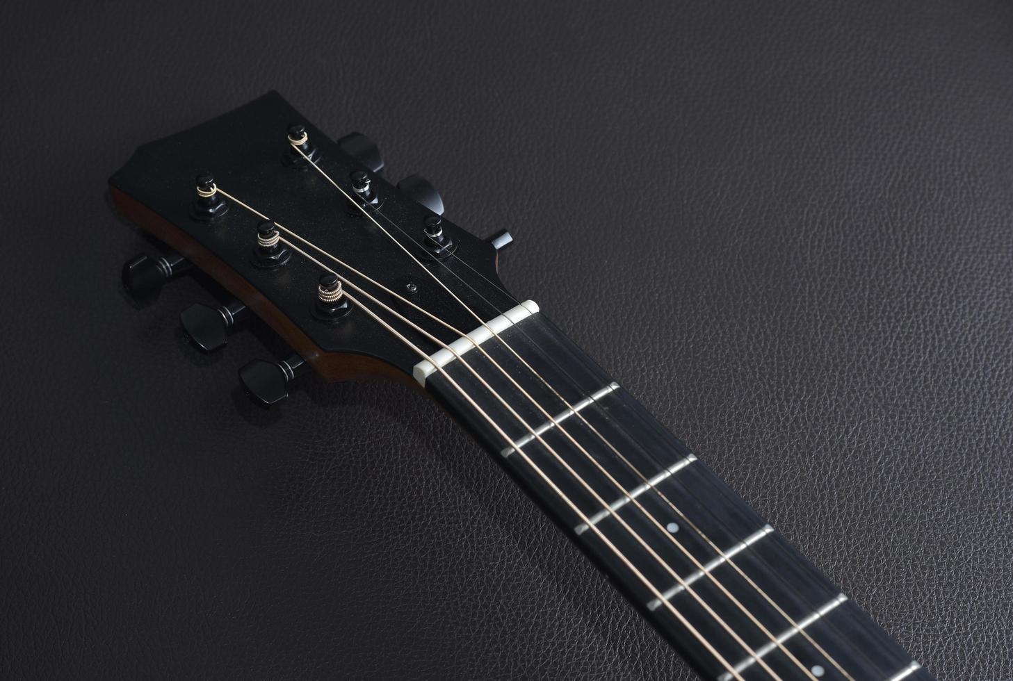 Acoustic guitar close-up on a beautiful colored background, the concept of stringed instruments photo