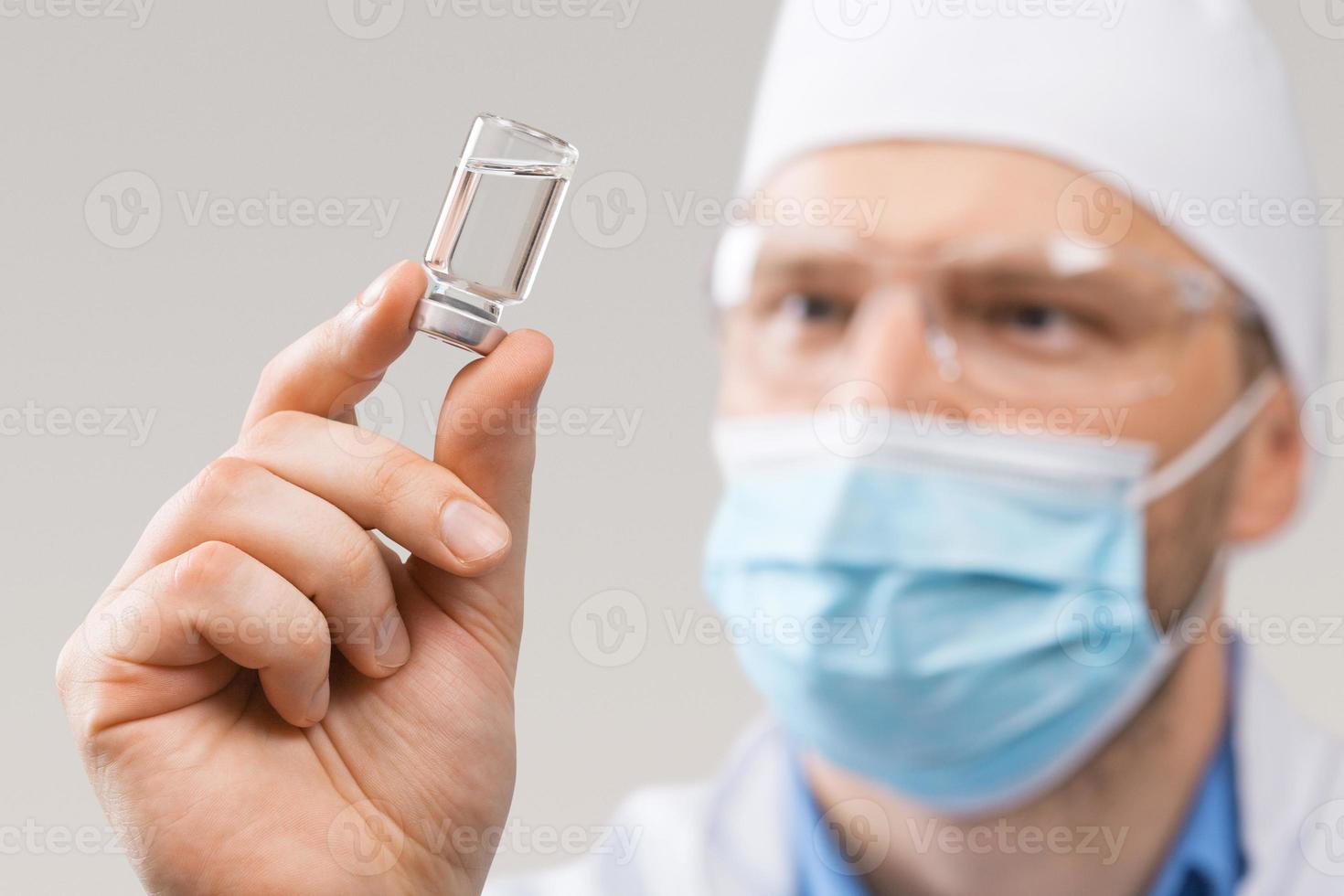 Doctor holding a viol with vaccine against corona virus. photo