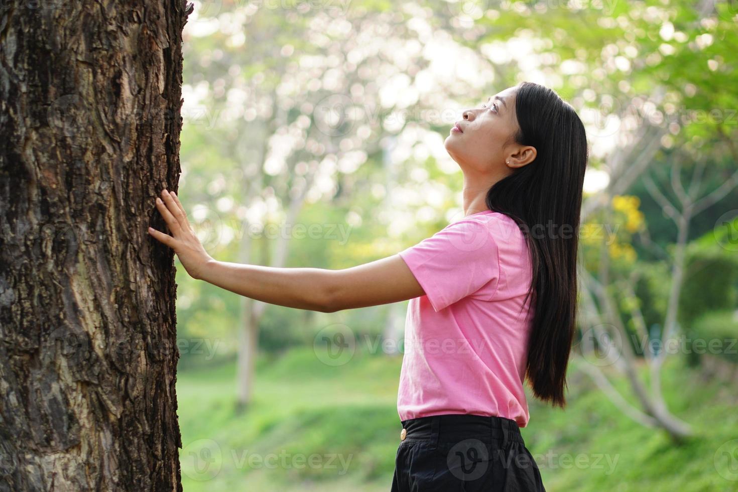 Asian women embrace trees with love, concept of love for the world photo