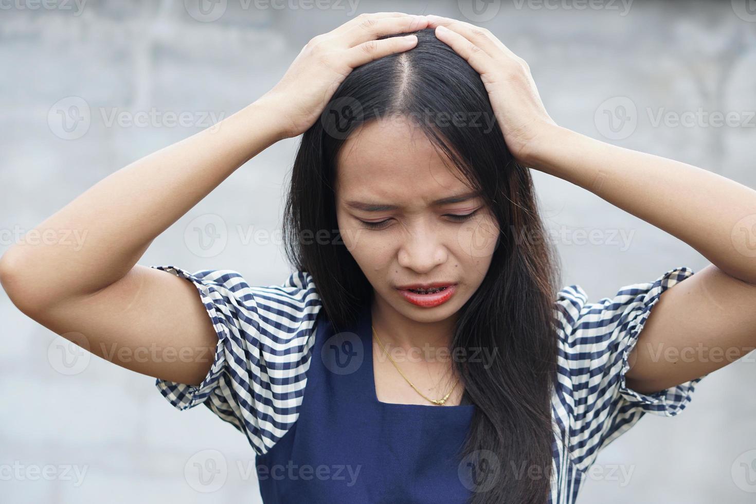 Fatigue overworked stressful female model keeps hands on temples, suffers from terrible headache, feels pain, wears pink shirt,Tiredness cocnept photo