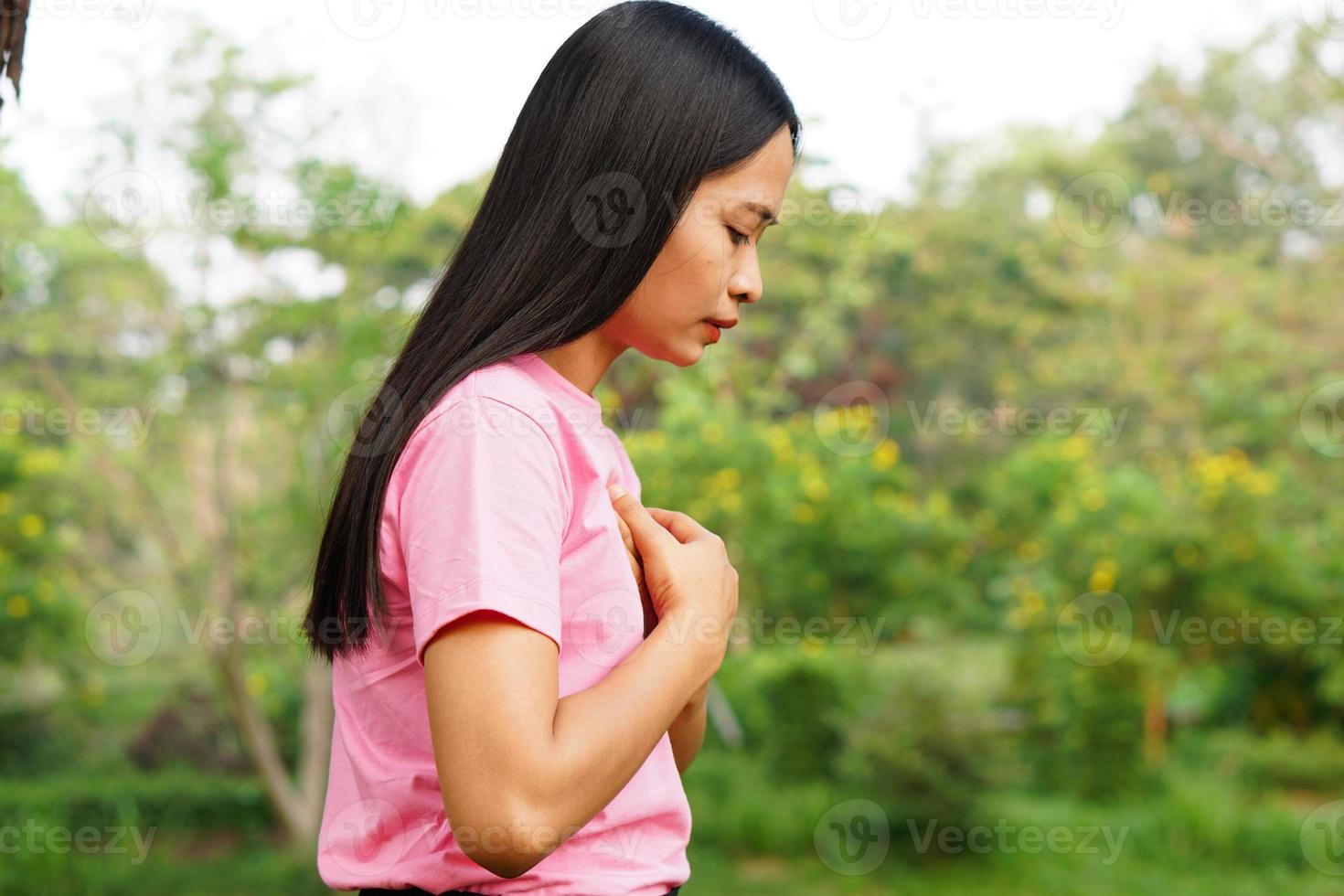 las mujeres asiáticas tienen opresión en el pecho. causado por enfermedades del corazón foto