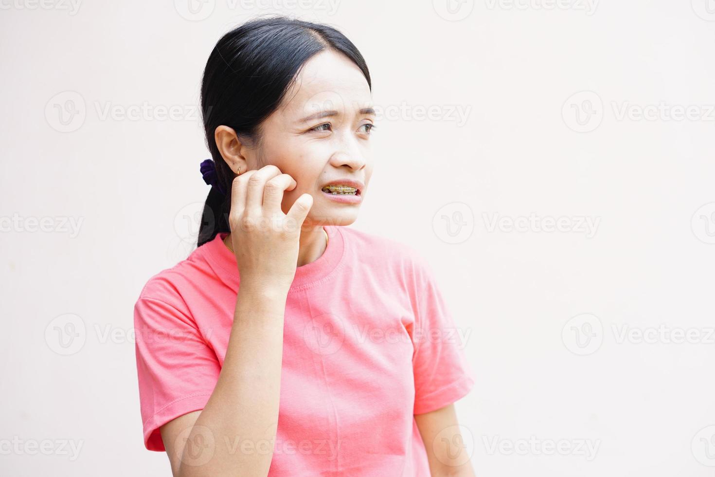las mujeres asiáticas tienen picazón en la cara. foto