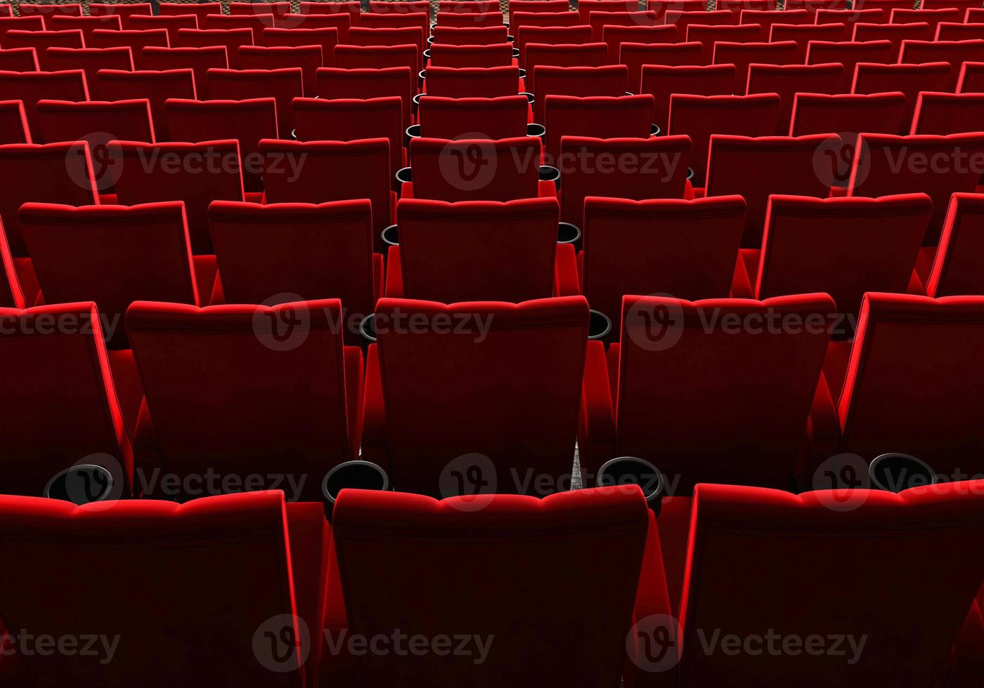 Rows of red velvet seats watching movies in the cinema with copy space banner background. Entertainment and Theater concept. 3D illustration rendering photo