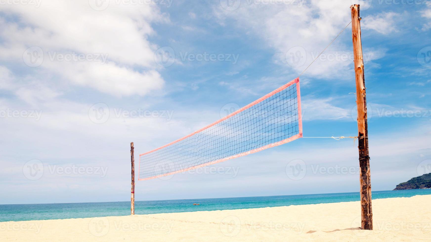 volleyball net on empty sand beach photo