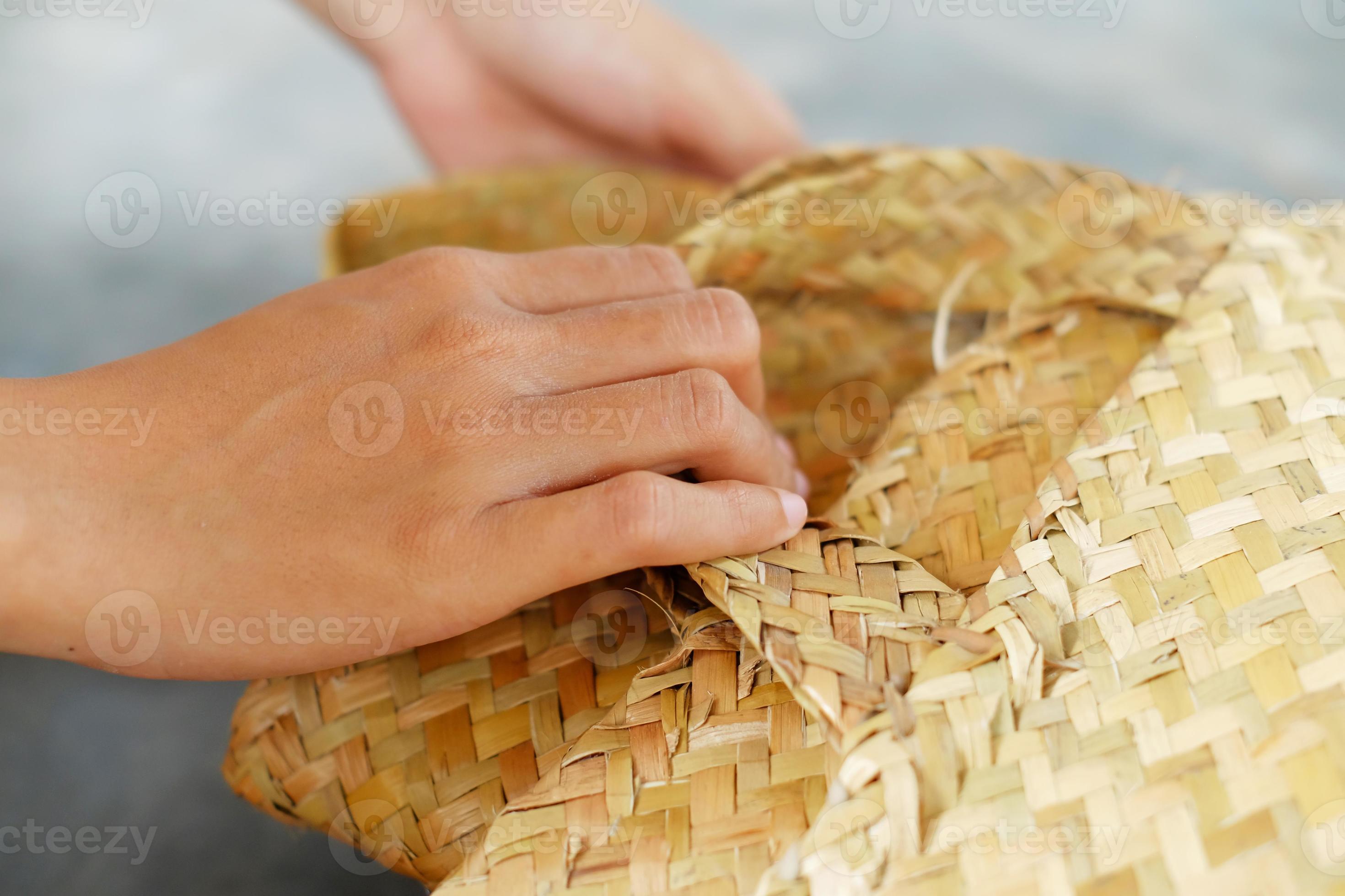 Woman carrying a basket made of pandan leaves. Rural women use pandan