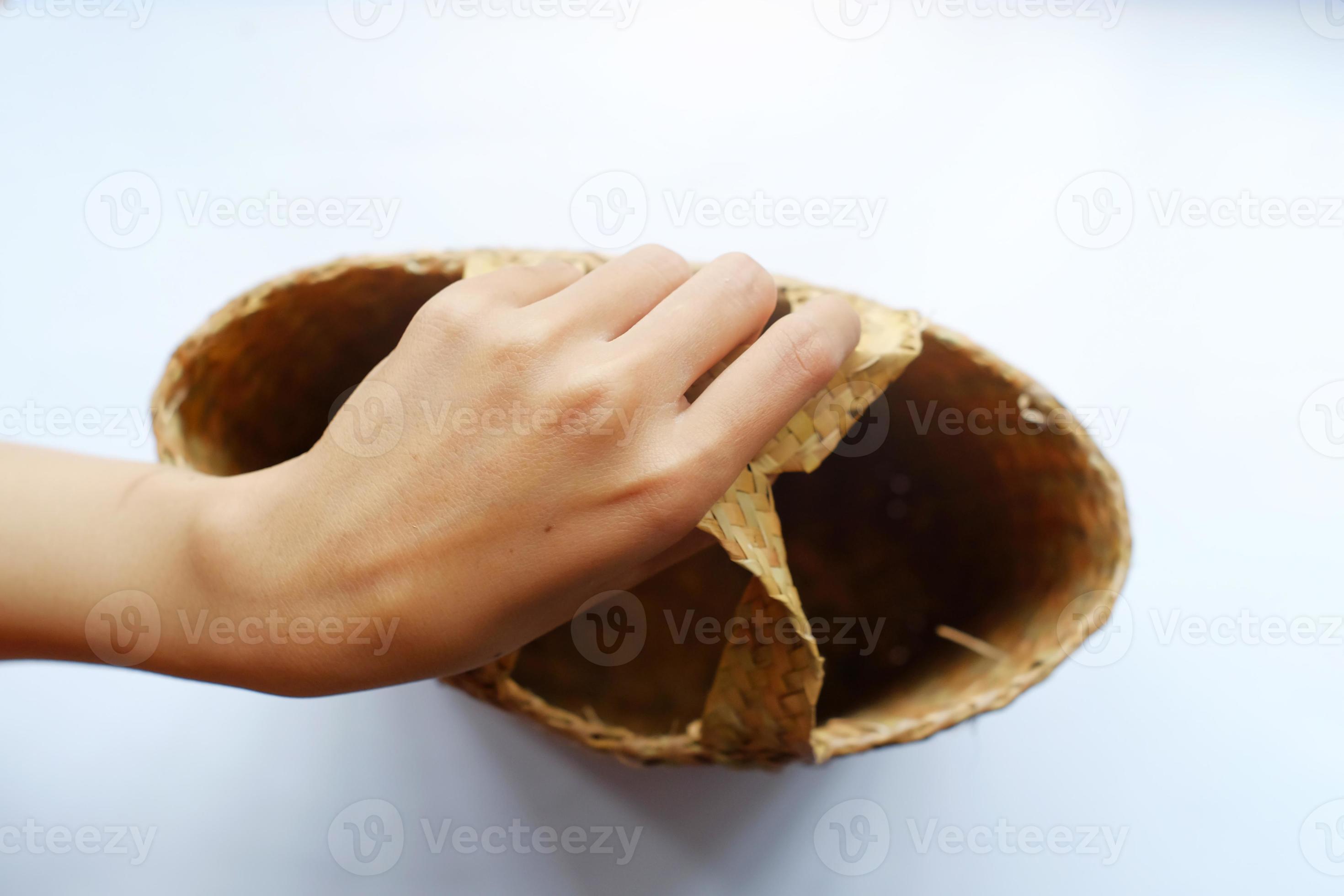 Woman carrying a basket made of pandan leaves. Rural women use pandan