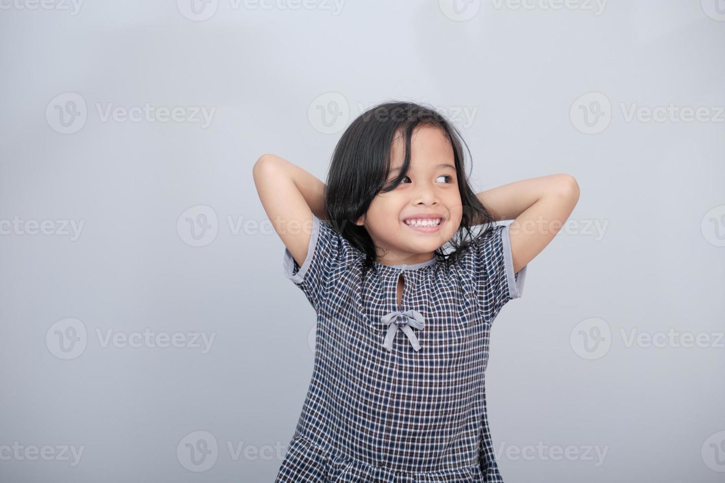 Portrait of a girl with both hands on head photo