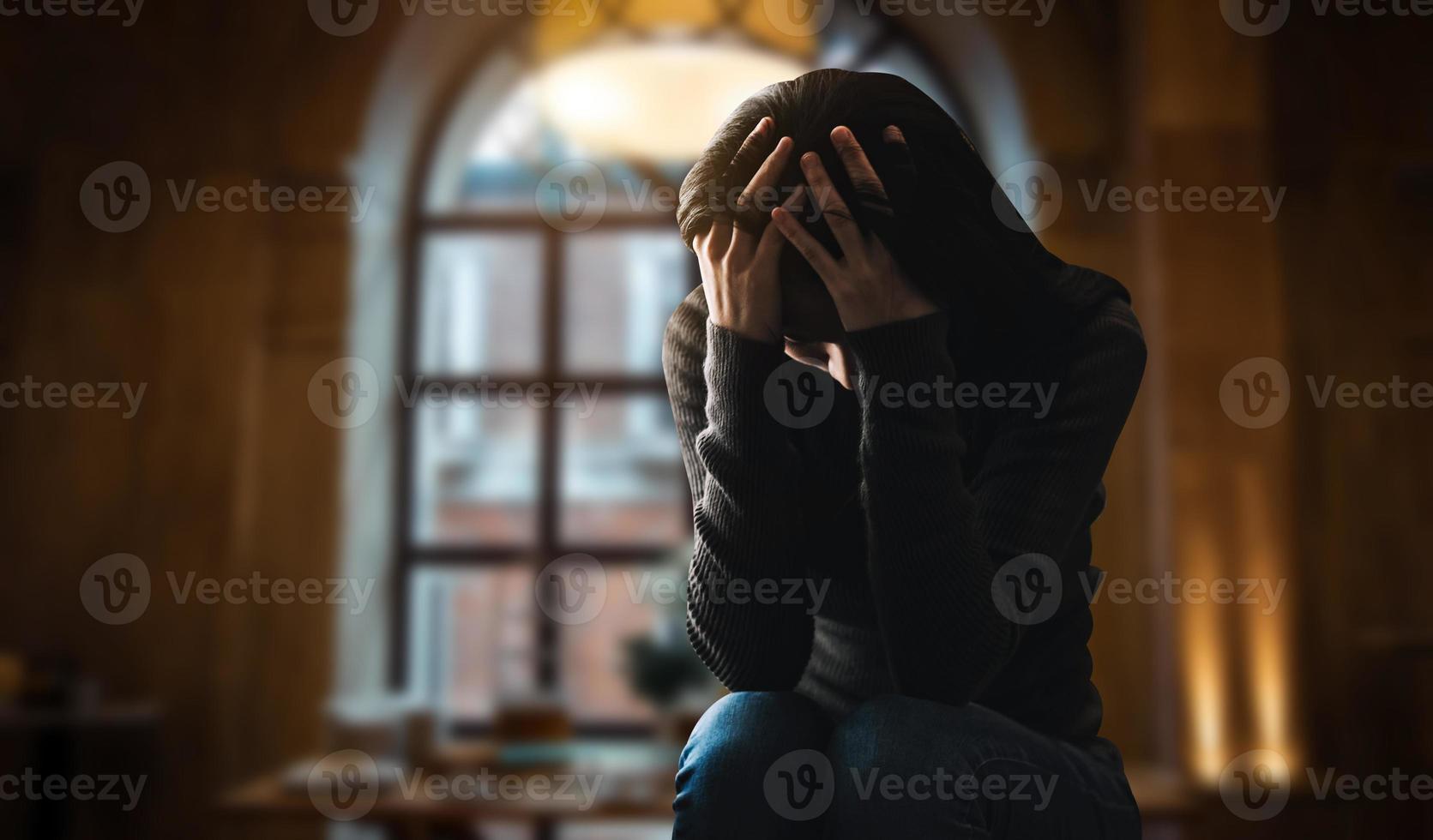 woman sit Depression Standing by window photo
