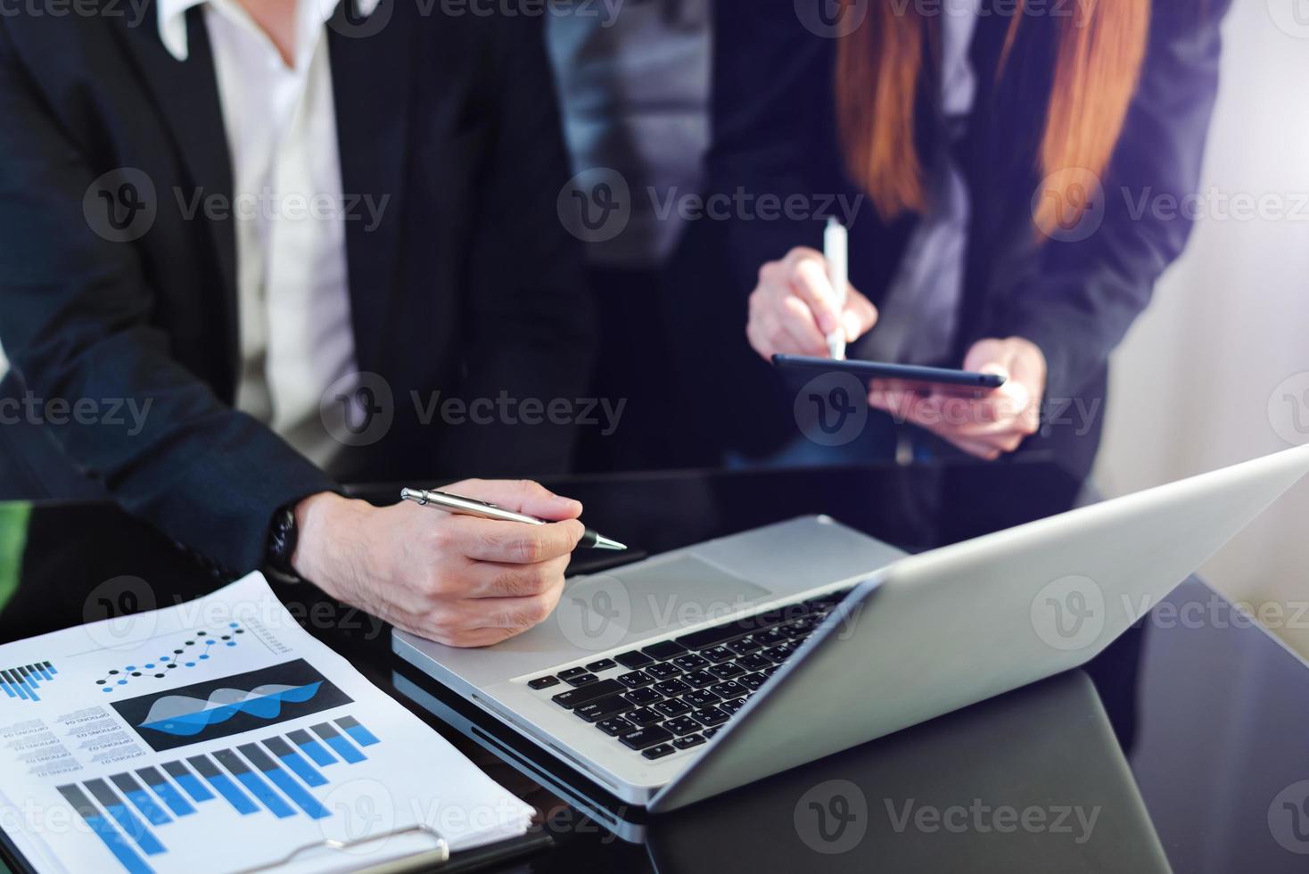 Business partners discussing documents and holding smartphone, tablet and ideas at meeting in morning light photo