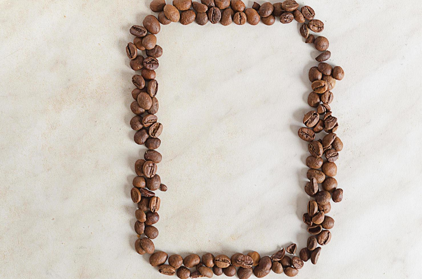 vertical frame of coffee beans on a light background photo