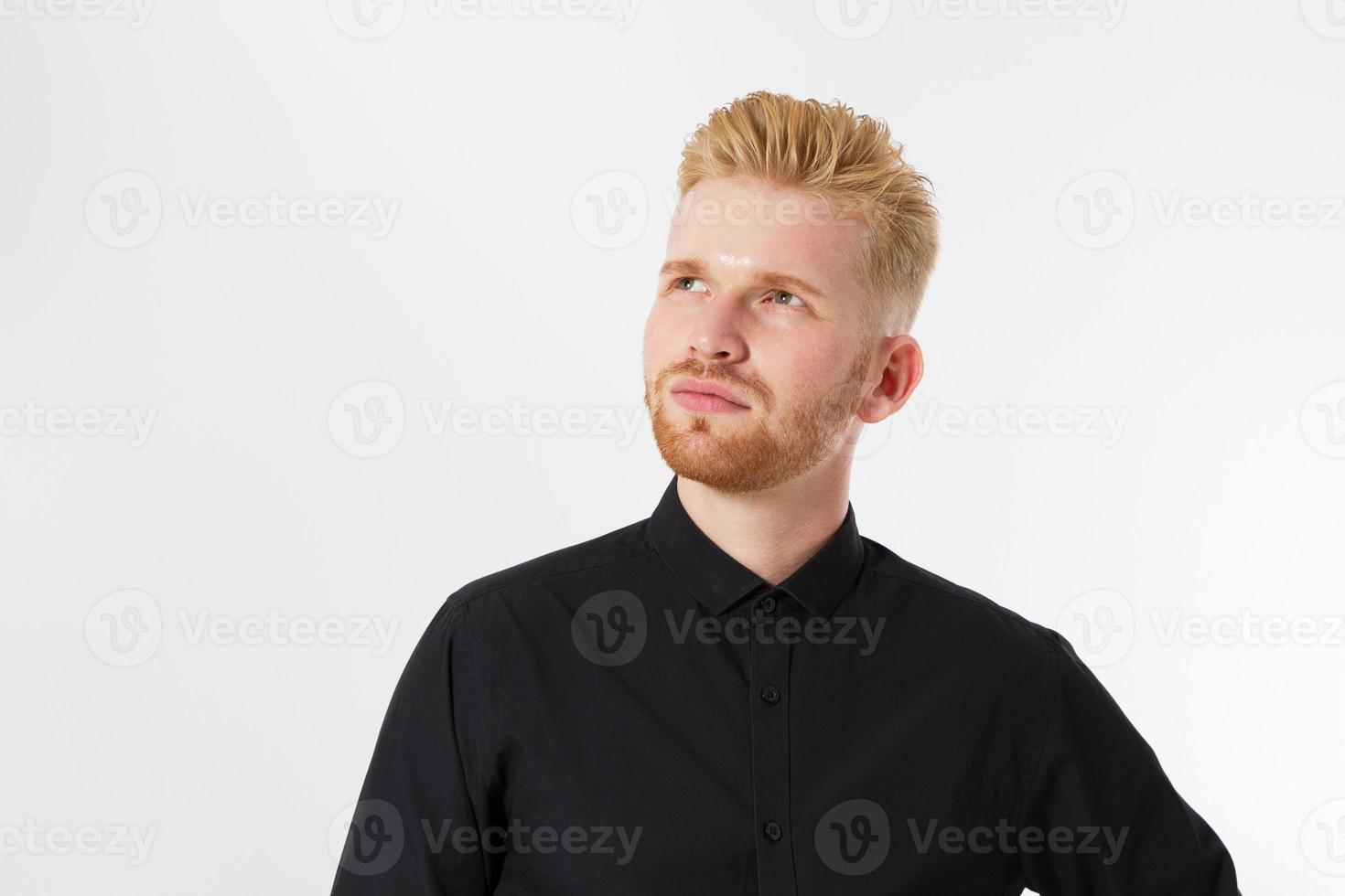 Man thinking, Red hair man serious thinking pensive portrait in studio isolated over white background, Young attractive man in black shirt photo