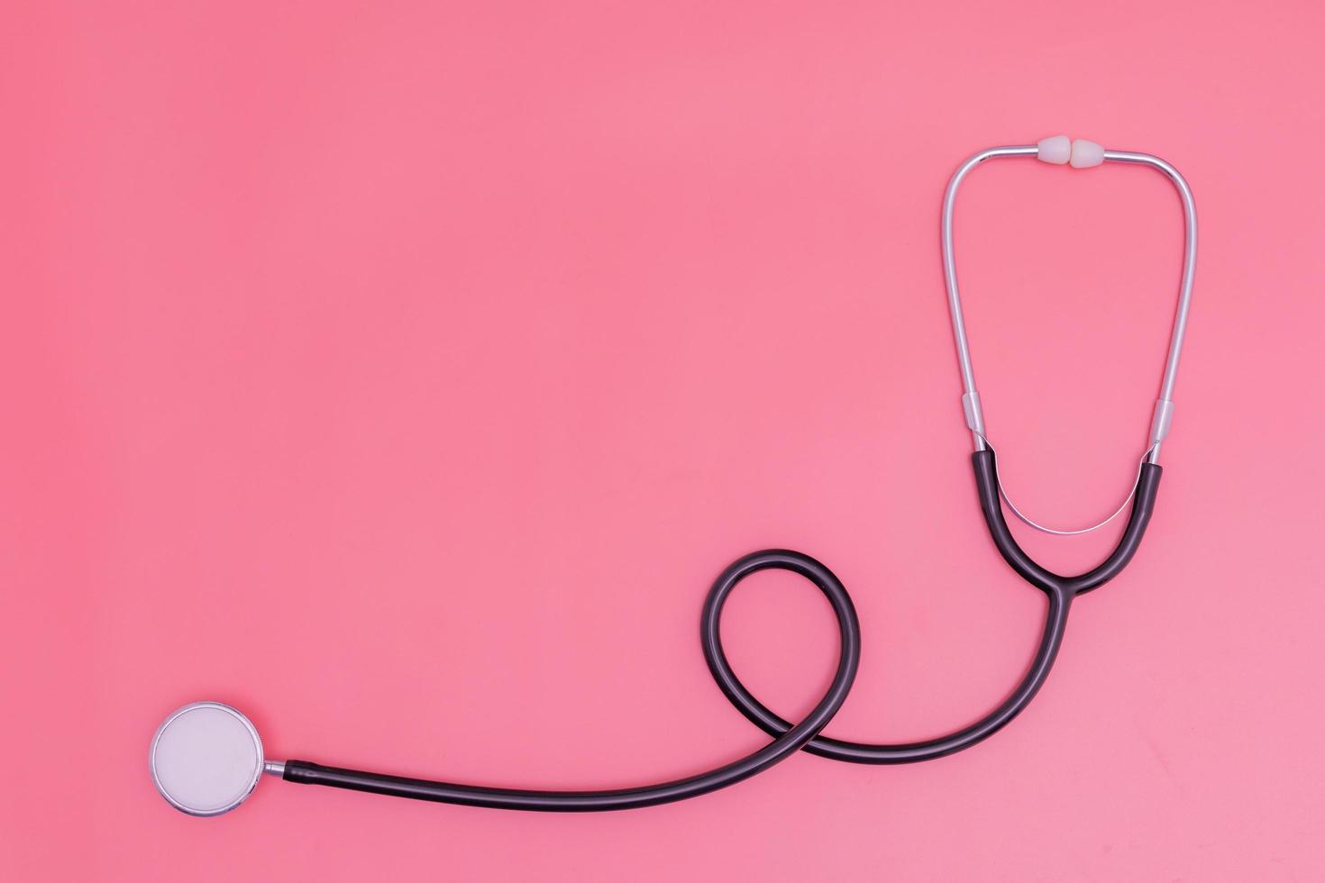 stethoscope on pink background and copy space photo