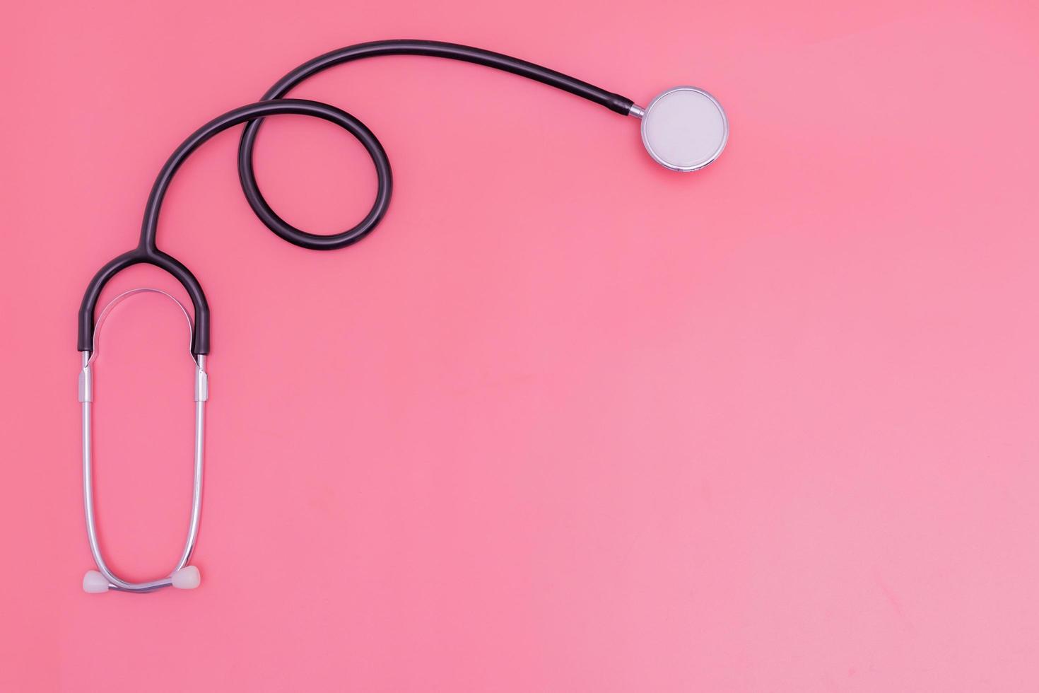 stethoscope on pink background and copy space photo