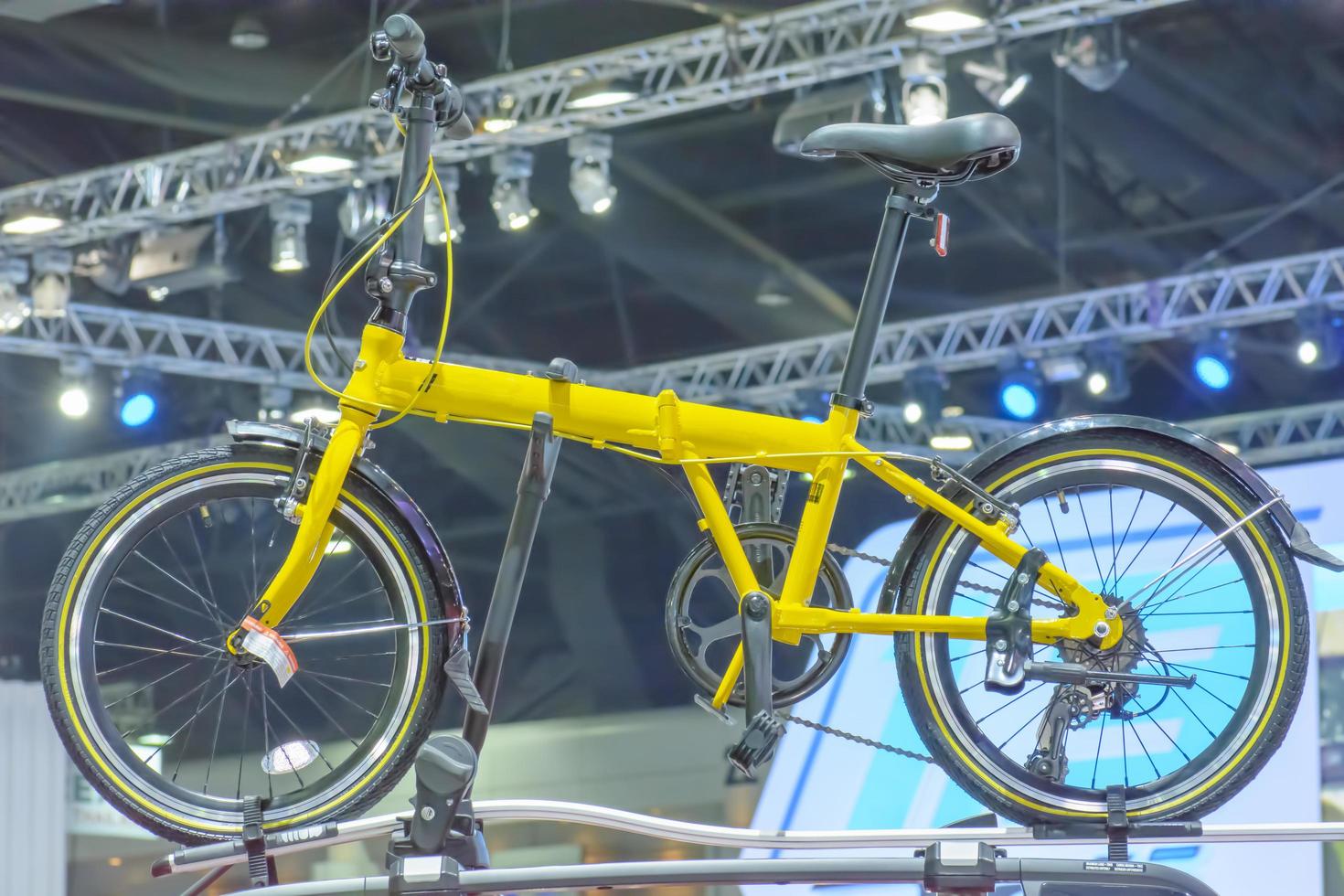 The bicycle is yellow color in the hall. photo