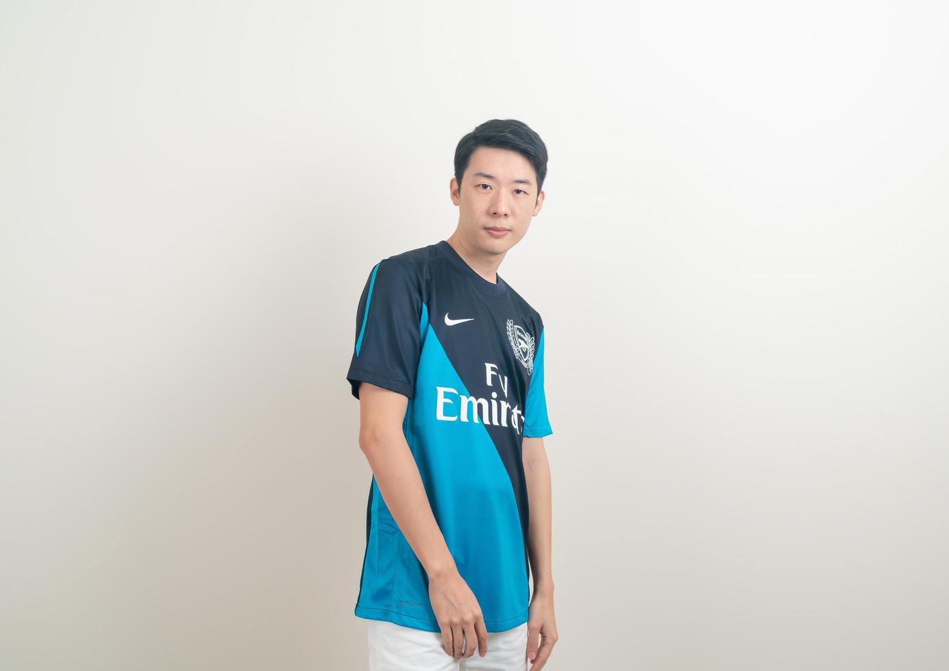 Bangkok, THAILAND - Nov 27, 2021 - Young Asian man wearing Arsenal shirt with white background. photo
