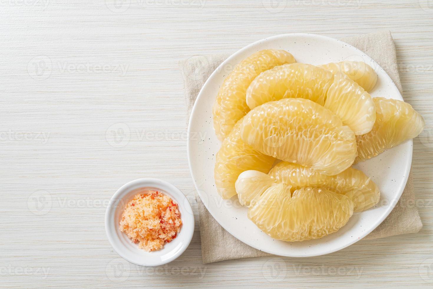 Fresh peeled pomelo, grapefruit or shaddock photo