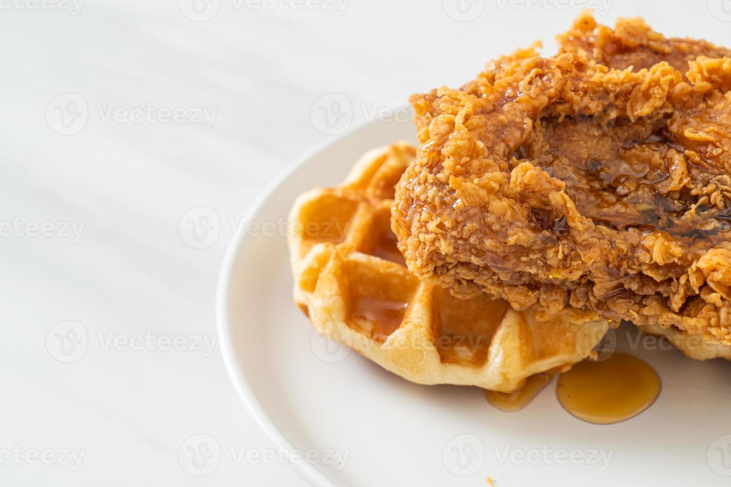 fried chicken waffle with honey or maple syrup photo