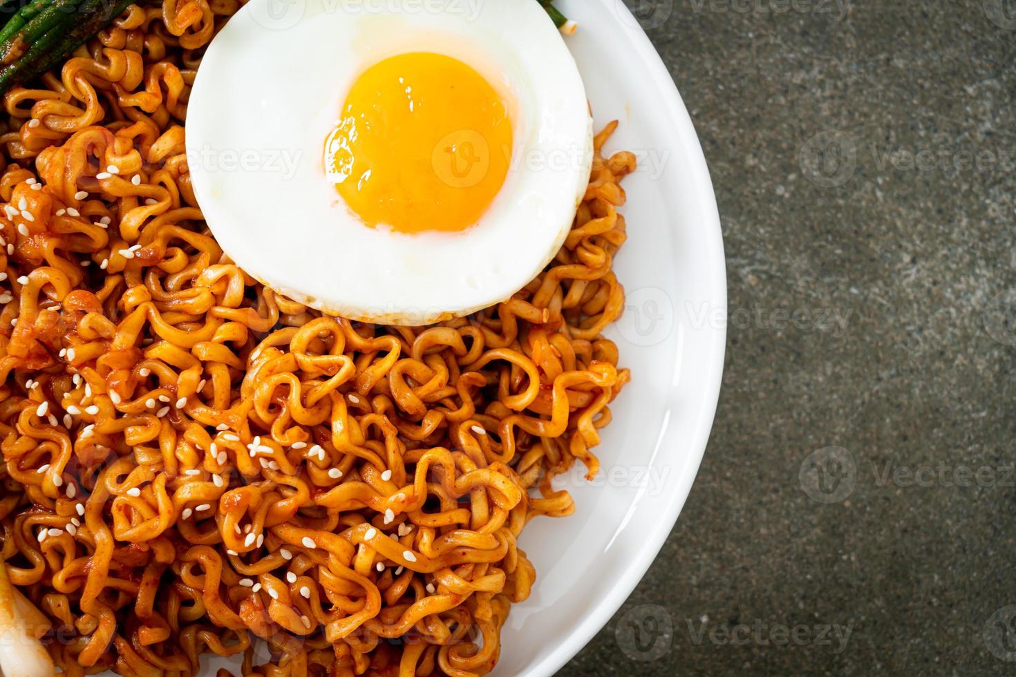 dried Korean spicy instant noodles with fried egg photo