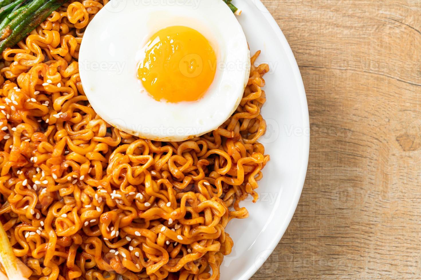 dried Korean spicy instant noodles with fried egg photo