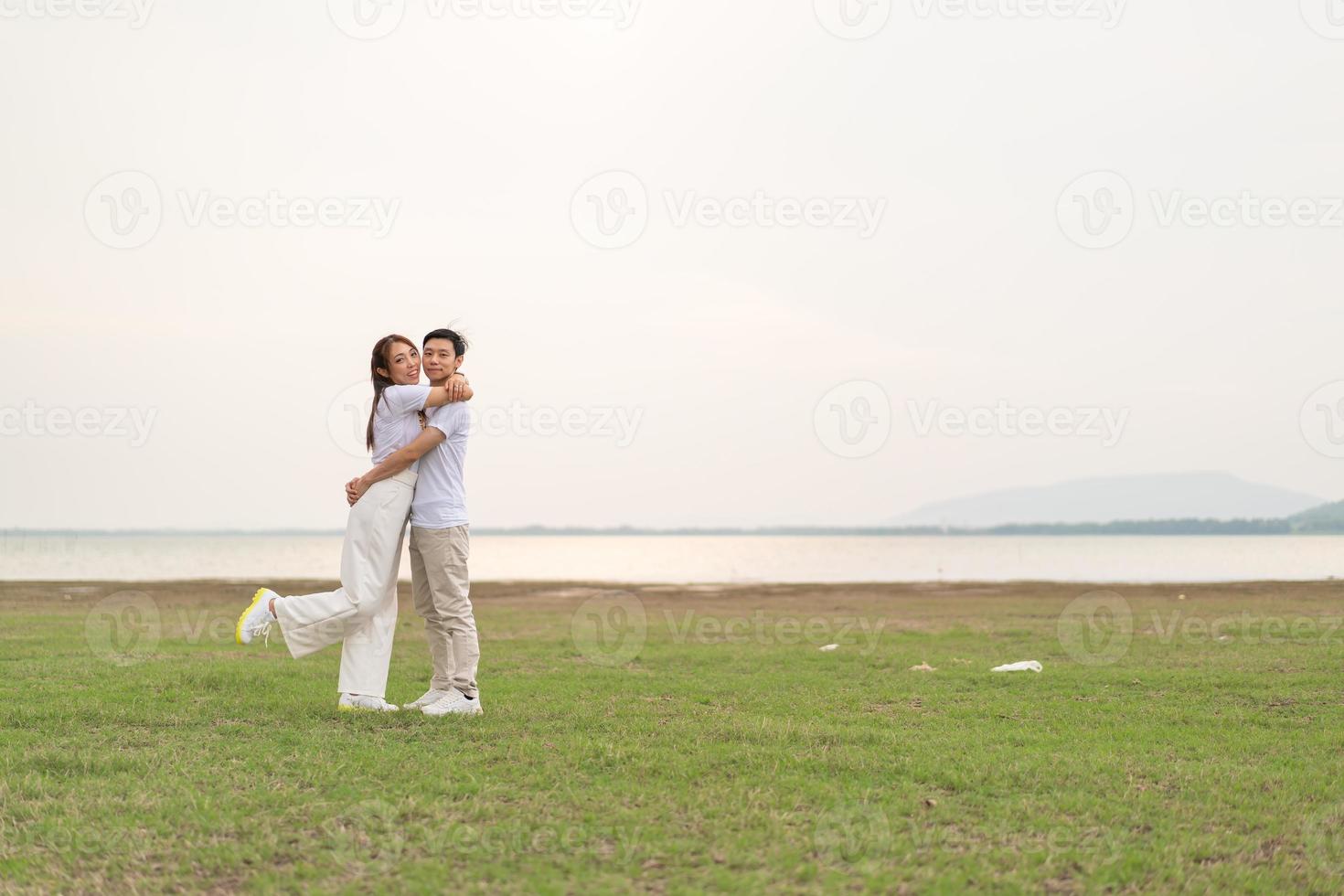 Happy young Asian couple in bride and groom t-shirt photo