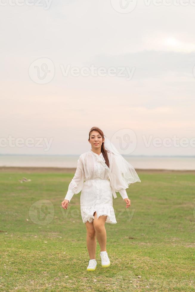 Happy young Asian women in bride clothing with veil photo