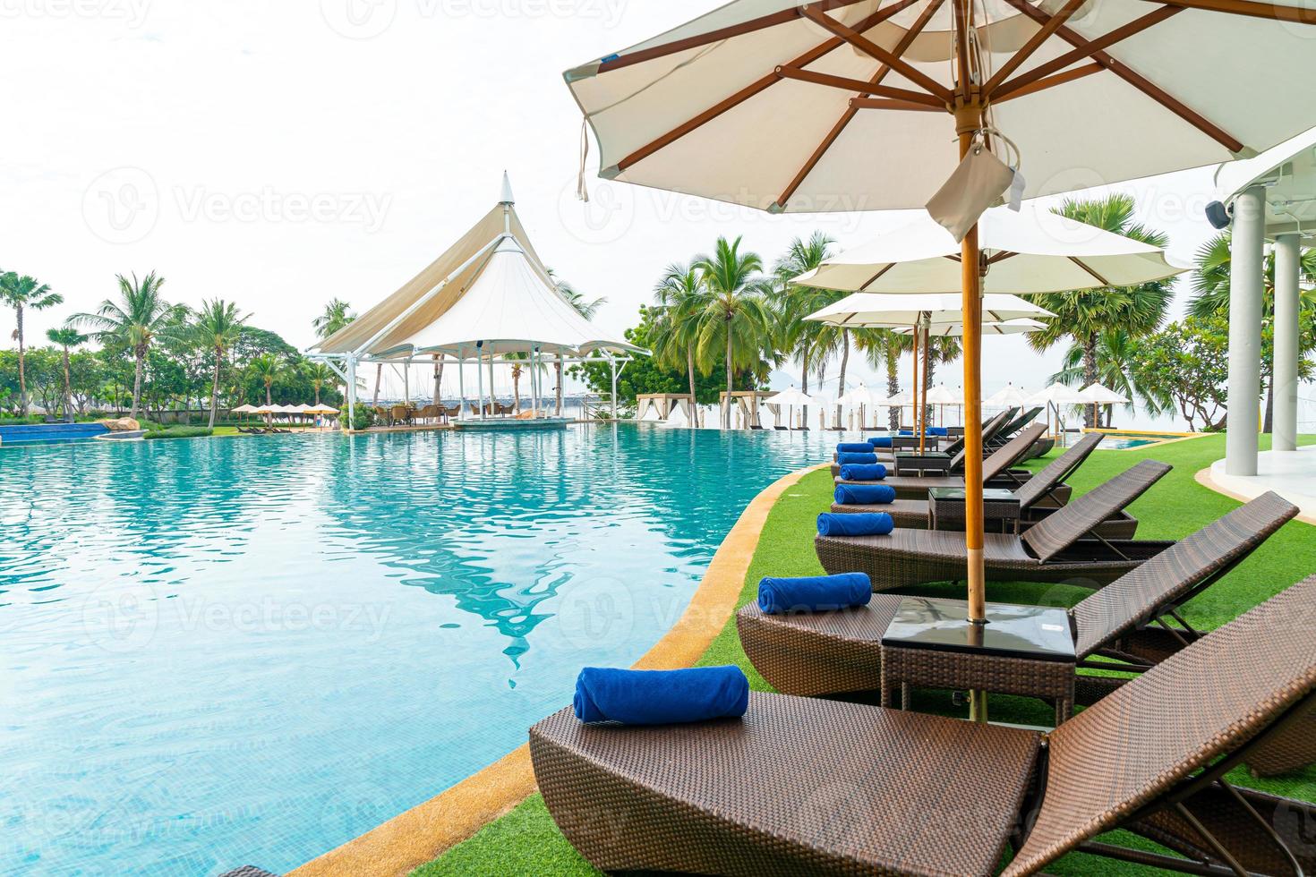 empty beach chair around swimming pool photo