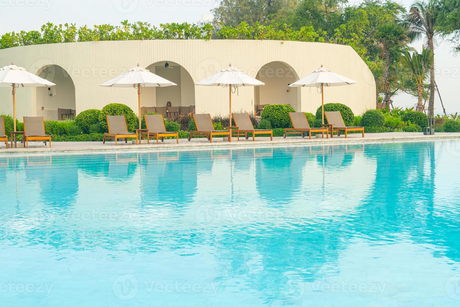 umbrella with bed pool around swimming pool with ocean sea background