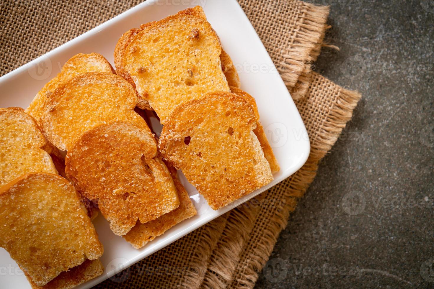 baked crispy bread with butter and sugar photo