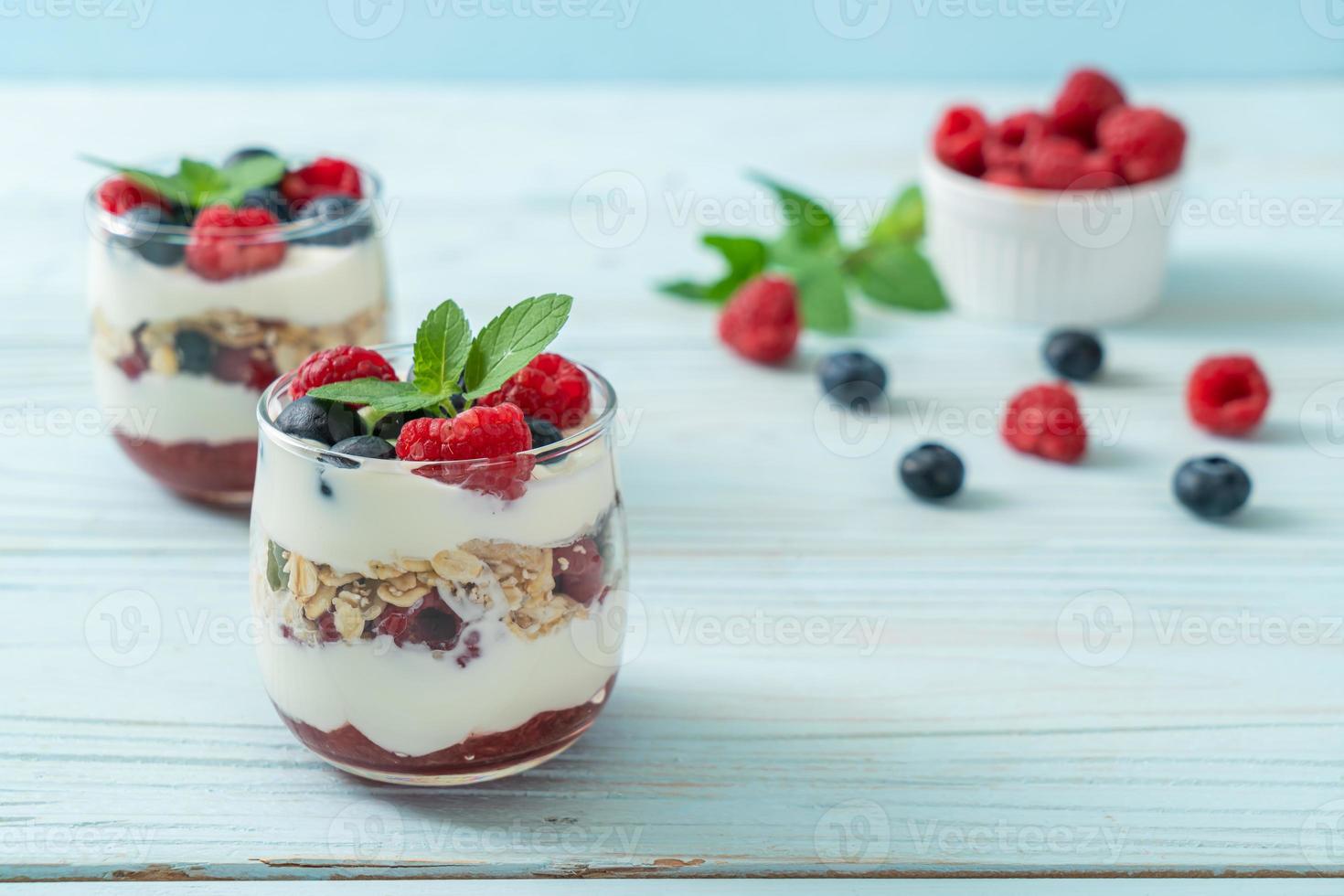 homemade raspberry and blueberry with yogurt and granola photo