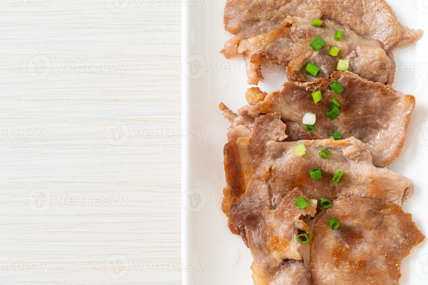 grilled pork neck sliced on plate photo