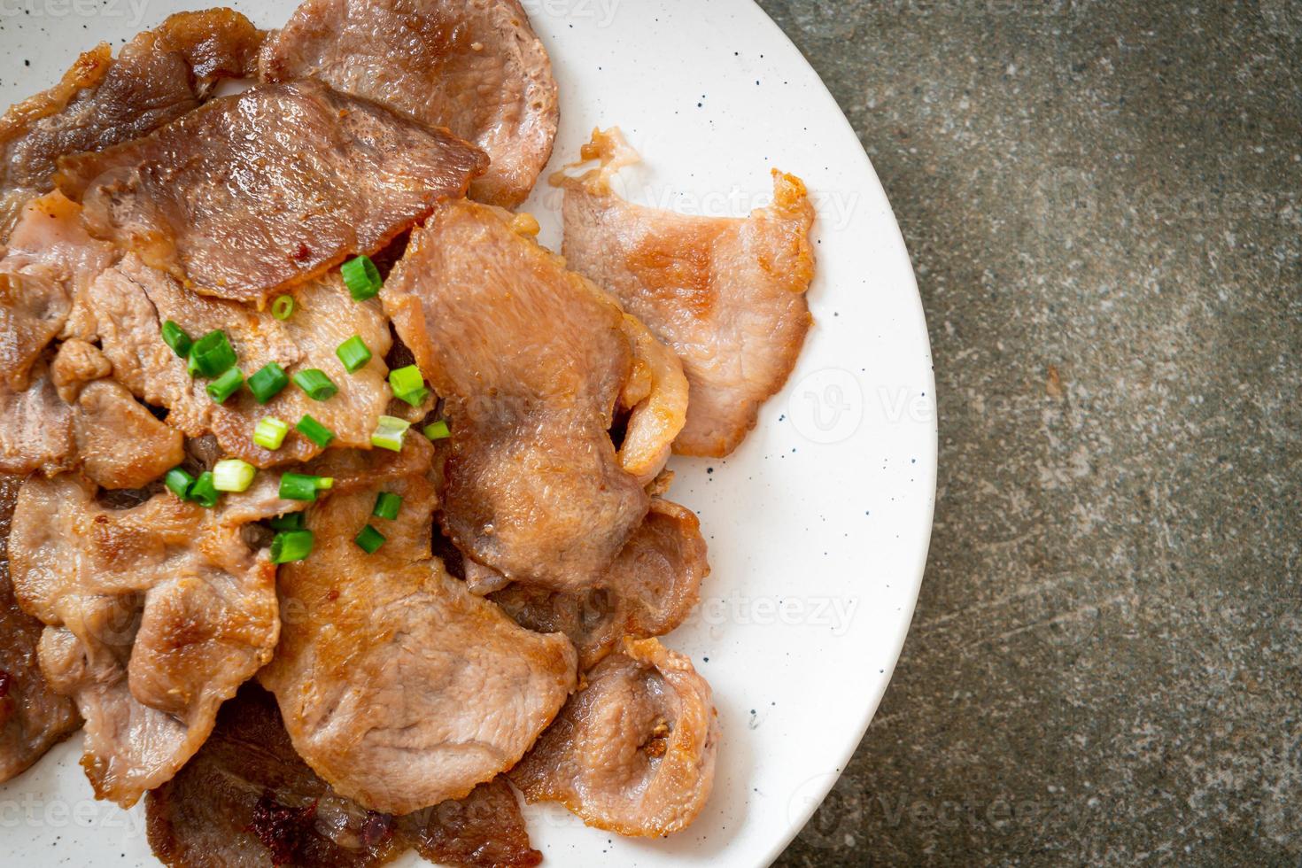 grilled pork neck sliced on plate photo