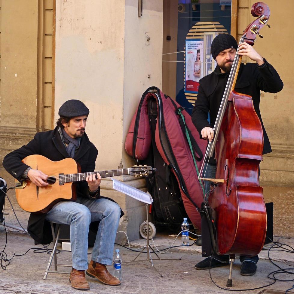 Modena, Italy, April 10, 2022, Street performers playing jazz music in the historic downtown district of Bologna. Busking on street concept. Italy photo