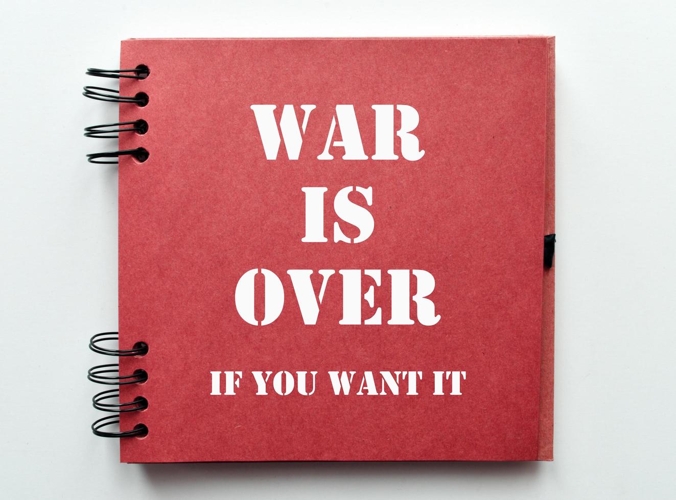 War is over, if you want it. Motivational quote on notebook paper. photo