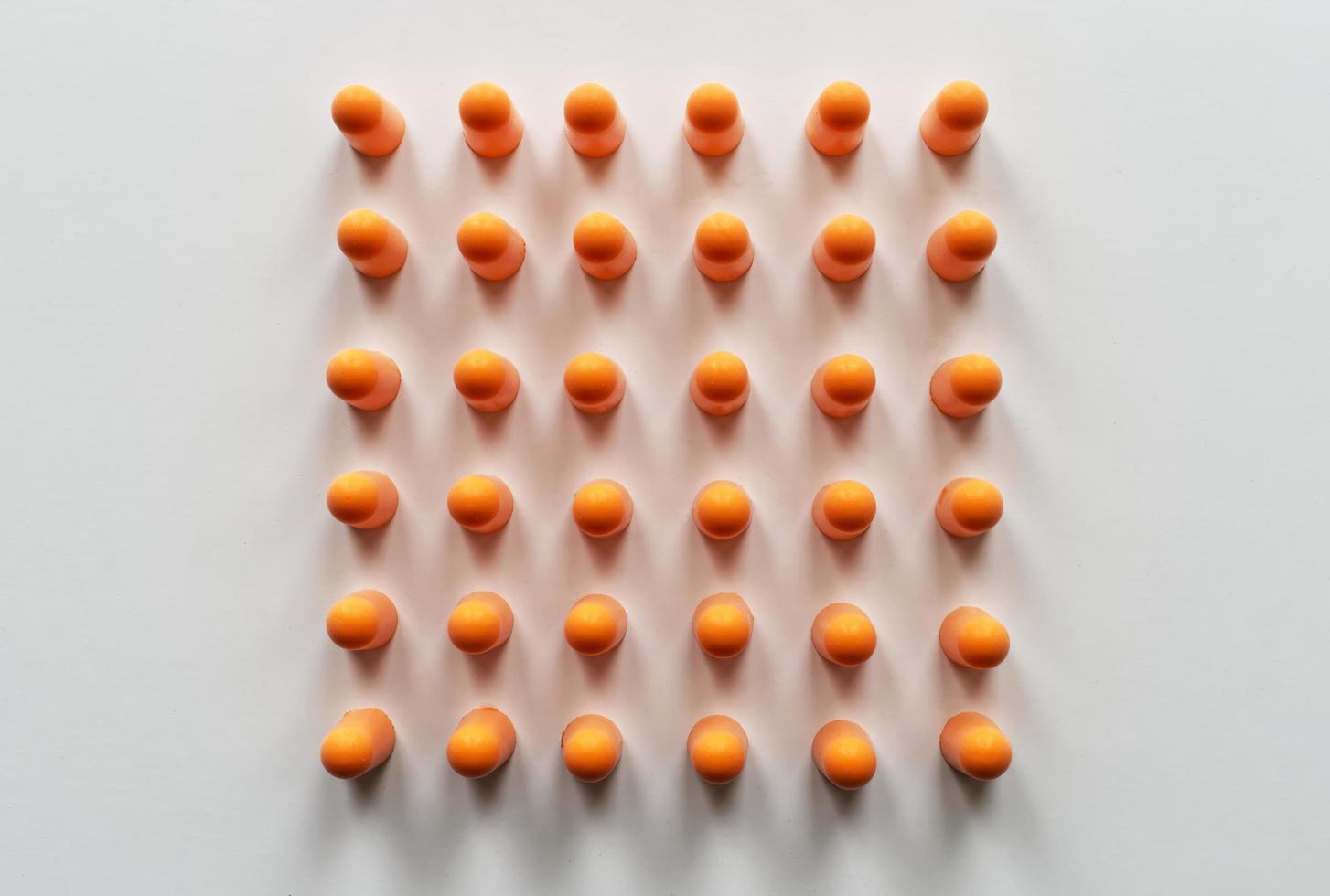 Orange foam ear plugs isolated on white background photo